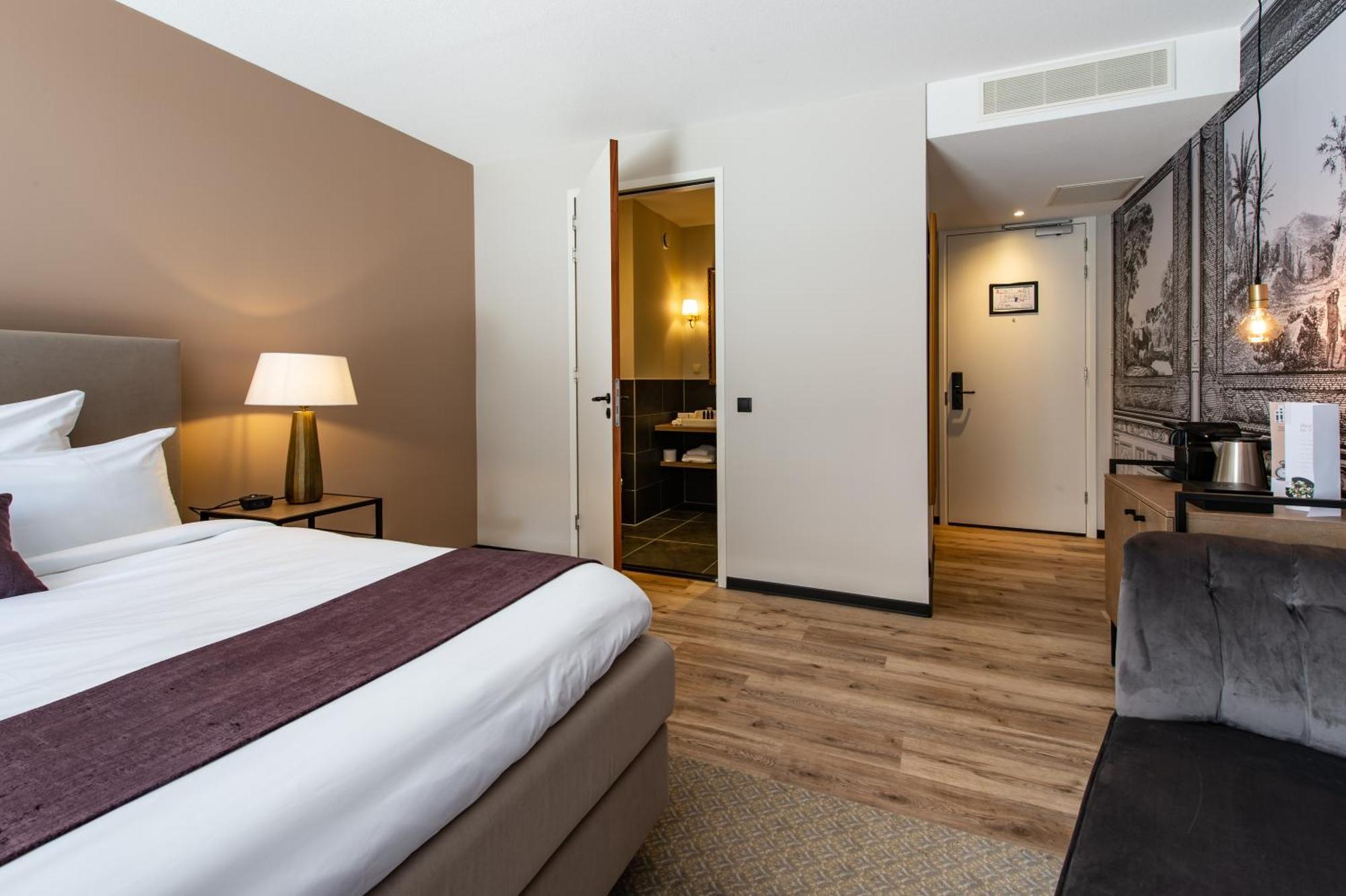 Zimmer mit Kingsize-Bett und Gartenblick.